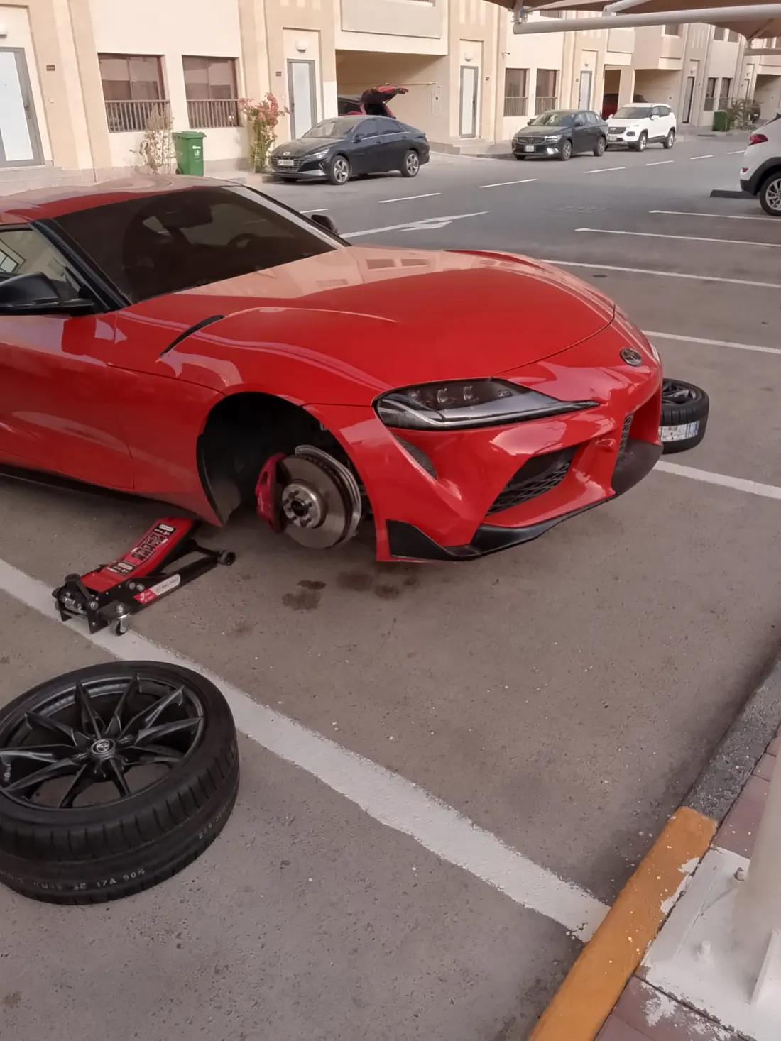 Mobile roadside brake service on a sports car in Doha